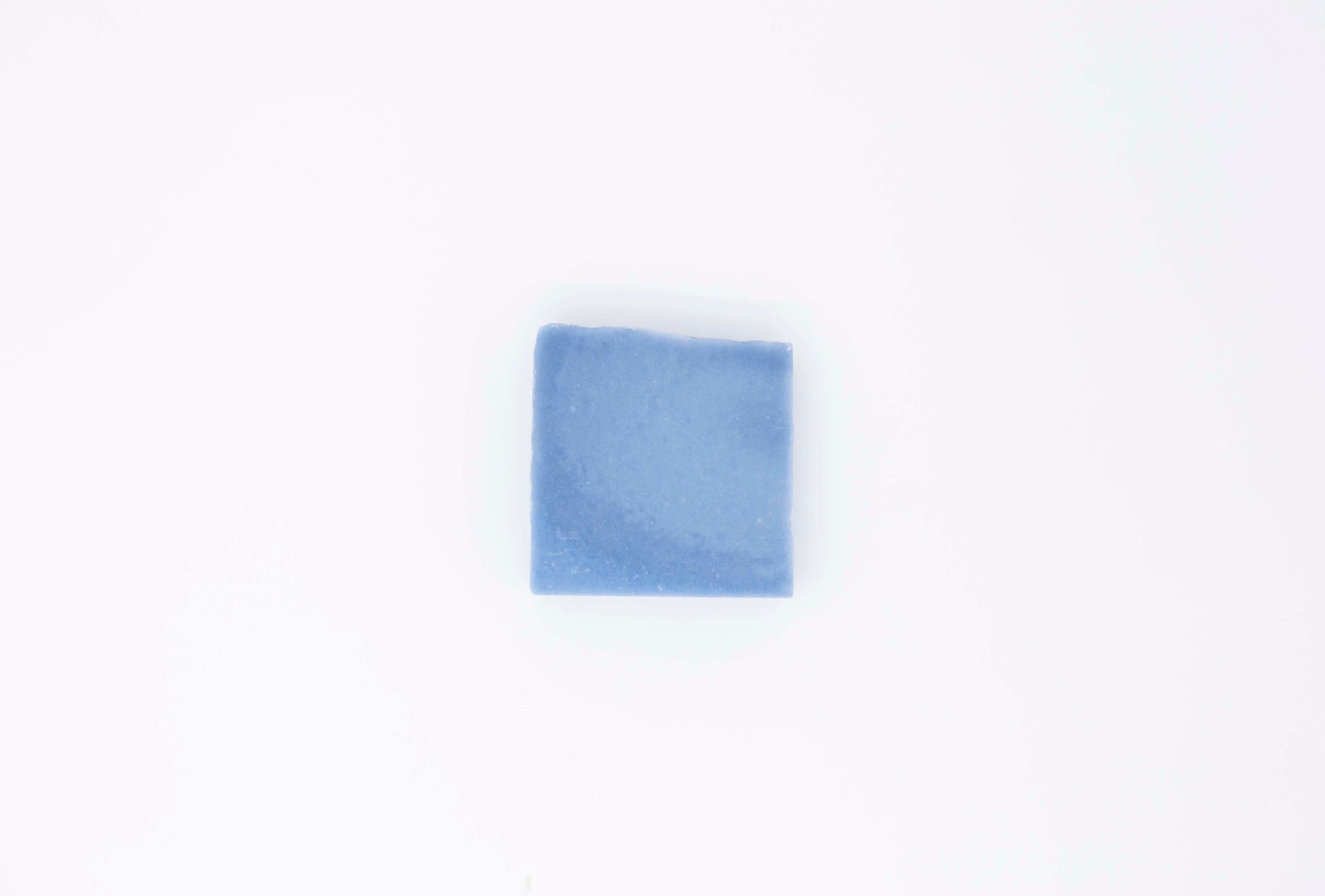 Royal cornflower blue eucalyptus soap bar  sits on a clean white background.